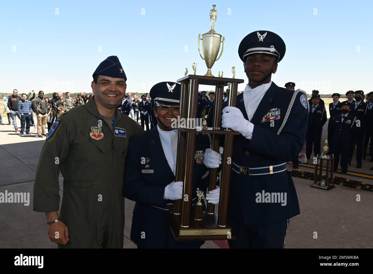 U.S. Air Force Col. Quaid Quadri, 169th Fighter Wing commander, presents the second overall trophy for the competition to Spring Valley High School during the annual Top Gun Drill Meet at McEntire Joint National Guard Base, South Carolina, March 26, 2022. High School Junior Reserve Officers Training Corps cadets from twenty high schools from across the state competed in twelve drill and ceremony events sponsored by the South Carolina Air National Guard. Stock Photo