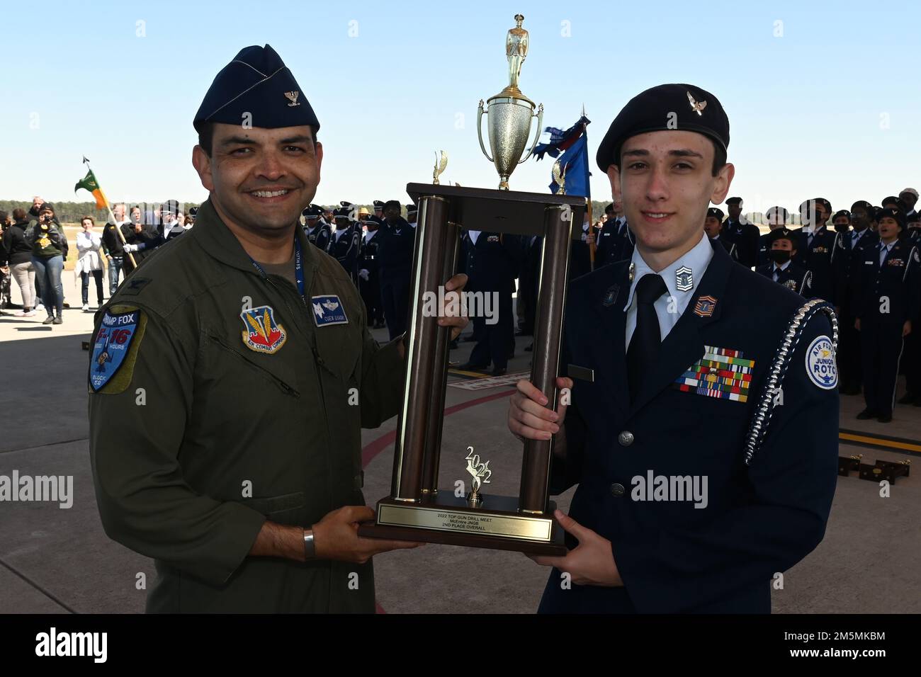 U.S. Air Force Col. Quaid Quadri, 169th Fighter Wing commander, presents the second overall trophy for the competition to Fort Dorchester High School during the annual Top Gun Drill Meet at McEntire Joint National Guard Base, South Carolina, March 26, 2022. High School Junior Reserve Officers Training Corps cadets from twenty high schools from across the state competed in twelve drill and ceremony events sponsored by the South Carolina Air National Guard. Stock Photo