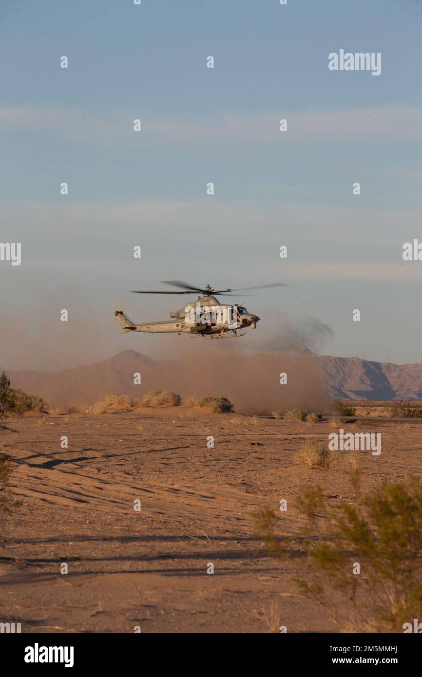 A U.S. Marine Corps UH-1Y Venom, lands at a forward arming and refueling point (FARP), during Weapons and Tactics Instructor (WTI) course 2-22, at Auxiliary Airfield II, near Yuma, Arizona, March 26, 2022. WTI is a seven-week training event hosted by MAWTS-1, providing standardized advanced tactical training and certification of unit instructor qualifications to support Marine aviation training and readiness, and assists in developing and employing aviation weapons and tactics. Stock Photo