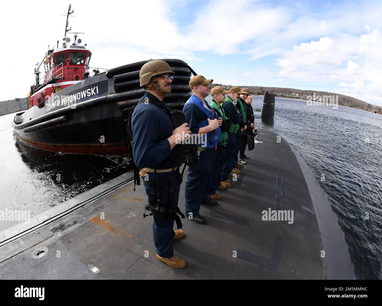 220326-N-GR655-0086 GROTON, Connecticut (March 26, 2022) – Crewmembers, attached to the Virginia-class submarine USS Delaware (SSN 791), depart the pier at Naval Submarine Base New London March 26, 2022. Delaware’s 132-man crew transited to Wilmington, Delaware to participate in week-long commemoration events in honor of the boat’s commissioning ceremony that took place administratively in April 2020 due to COVID restrictions at the time. Delaware, the seventh U.S Navy ship and first submarine named after the first U.S. state of Delaware, is a flexible, multi-mission platform designed to carry Stock Photo