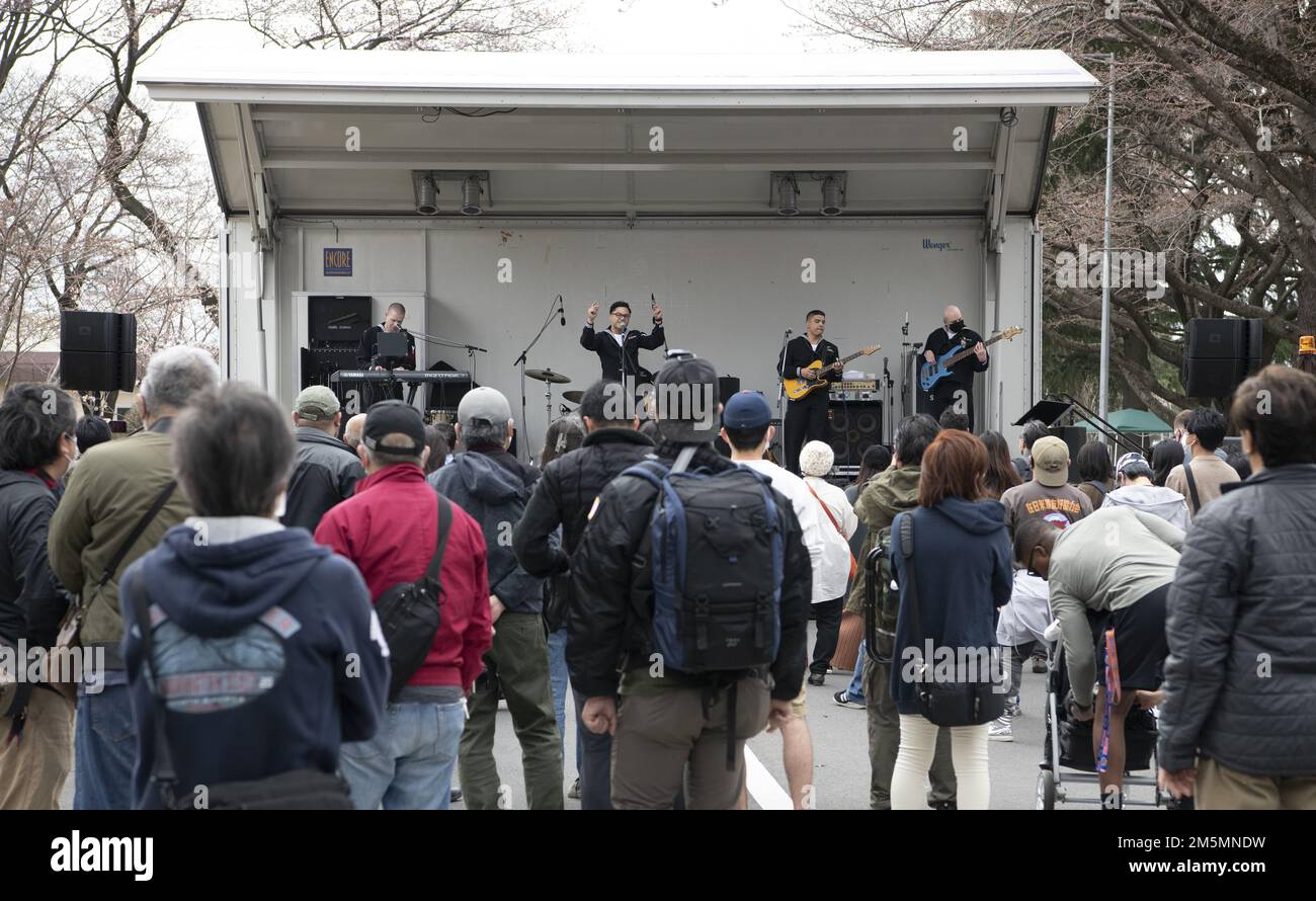 U.S. Navy Sailors assigned to the U.S. 7th Fleet Band, perform for service members and the Japanese community during the Sakura Spring Festival March 26, 2022, at Yokota Air Base, Japan. The Sakura Festival is a bilateral event aimed at enhancing the U.S. and Japanese relationship. The festival offered a variety of entertainment such as live performances and food booths to the approximate 6,000 attendees; offering a chance for Japanese citizens to experience American culture on base. Stock Photo