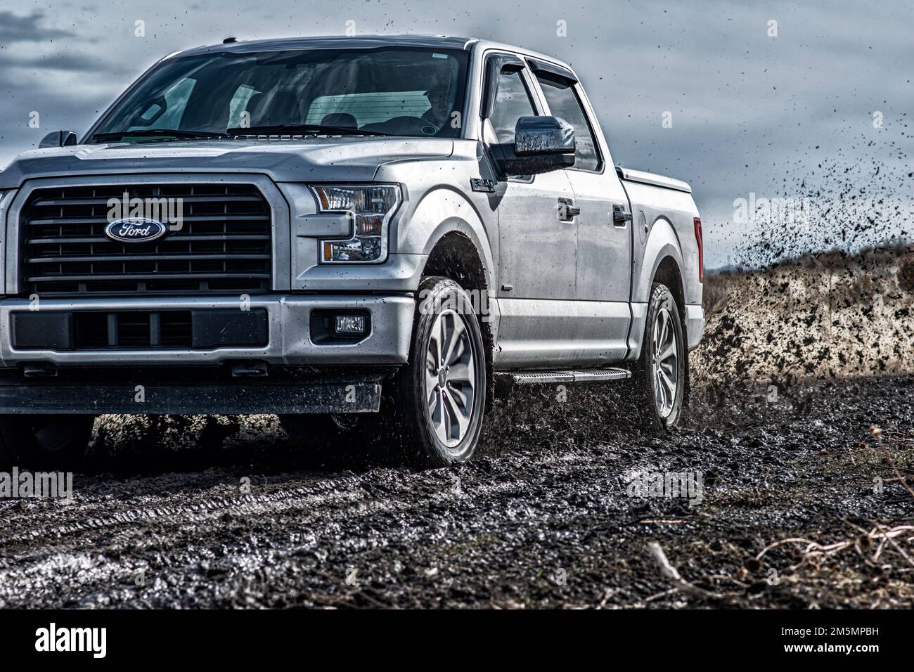 The Ford F150 Silver Truck Car 4x4 SUV driving in the mud Stock Photo