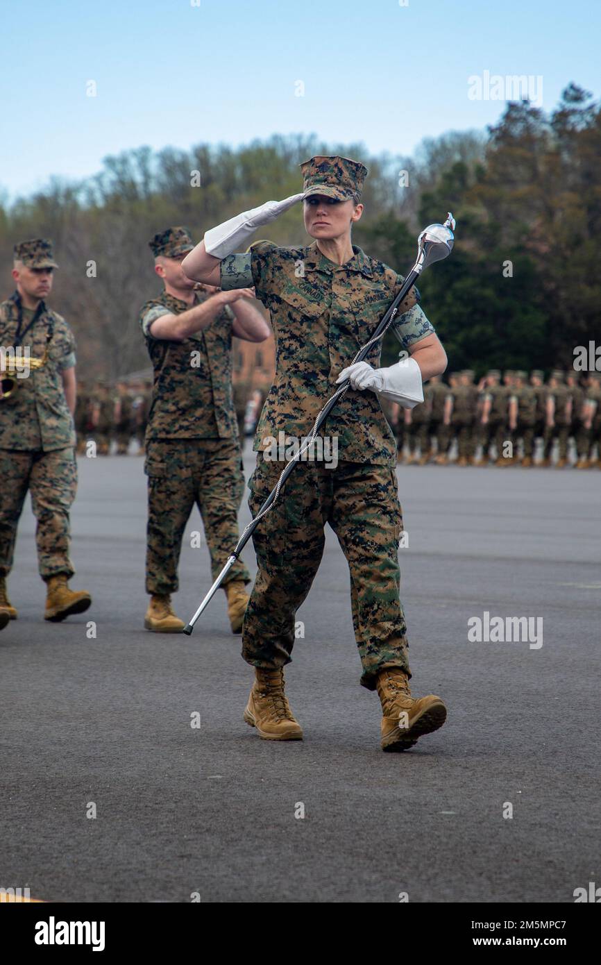 U.S. Marine Corps Sgt. Lauren E. Cannady, drum major of Marine Corps Base Quantico Band, salutes the reviewing officer at Brown field on Marine Corps Base Quantico, March 26, 2022. The mission of Officer Candidates School is to educate and train officer candidates in Marine Corps knowledge and skills within a controlled and challenging environment in order to evaluate and screen individuals for the leadership, moral, mental, and physical qualities required for commissioning as a Marine Corps officer. Stock Photo