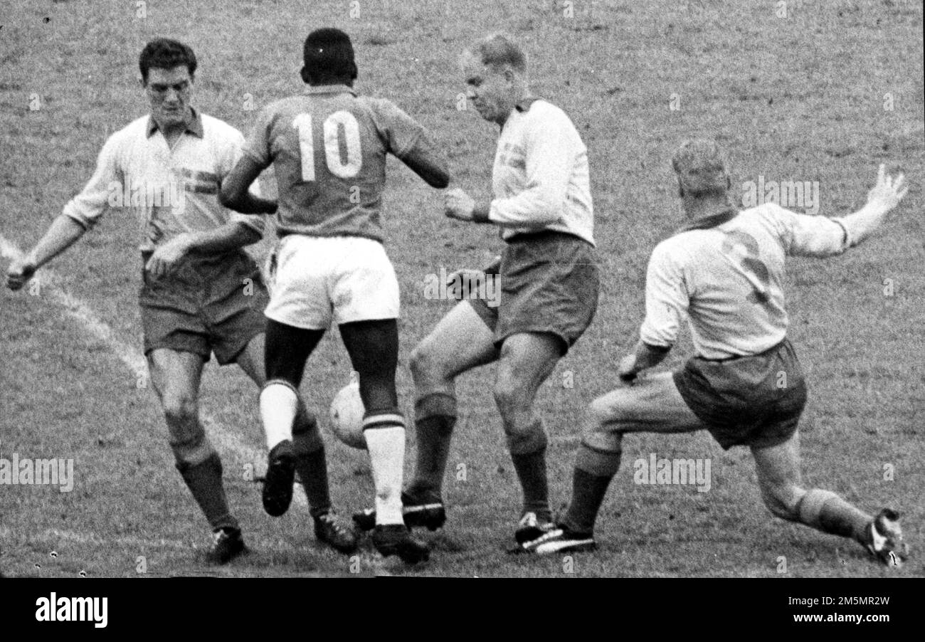 Swedish players Julle Gustavsson (left), Sigge Parling and Sven Axbom (right) are trying to stop Brazilian player number 10 Pelé during the final of the 1958 FIFA World Cup Football Championships in Stockholm, Sweden June 29, 1958. Brazil won the match ( 5-2).Photo Charlie Raasum / Sydsvenskan / TT code 73041 Stock Photo