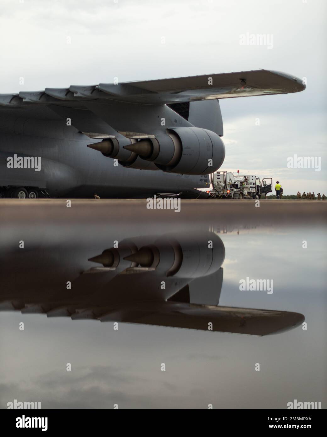 A Lockheed C-5M Super Galaxy, operated by the 22nd Airlift Squadron, Air Mobility Command, sits on the runway while being refueled during a movement of equipment at Royal Australian Air Force Base Darwin, NT, Australia, March 27, 2022. The C-5M will be moving U.S. Marine Corps equipment from Darwin to Okinawa, Japan, an initiative by Marine Rotational Force-Darwin 22, ensuring the equipment is operational to maintain a credible crisis and contingency-ready force that can contribute to a free and open Indo-Pacific region. Stock Photo