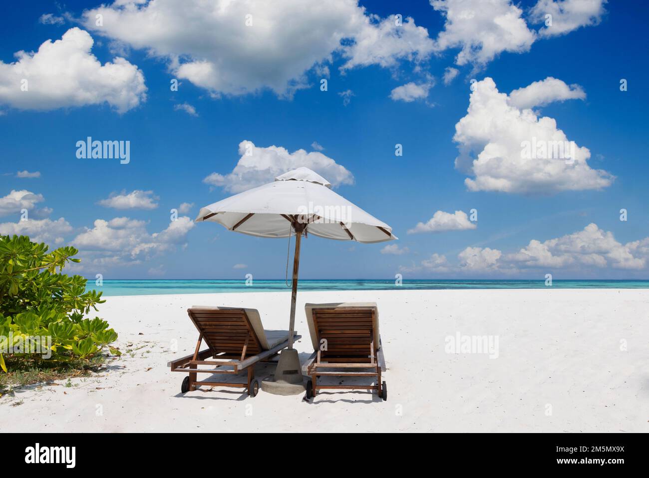 Amazing vacation panorama on summer island beach. Two chairs with palm leaves and umbrella, close seaside, horizon. Exotic landscape tropical paradise Stock Photo