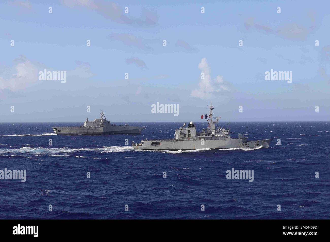 220328-O-NR876-494  PHILLIPPINE SEA (March 28, 2022) – The French frigate FS Vendémiaire (F 734), right, maneuvers alongside the Independence-variant littoral combat ship USS Charleston (LCS 18) during an exercise in the Philippine Sea. Charleston, part of Destroyer Squadron (DESRON) 7, is on a rotational deployment, operating in the U.S. 7th Fleet area of operations to enhance interoperability with partners and serve as a ready-response force in support of a free and open Indo-Pacific region. Stock Photo