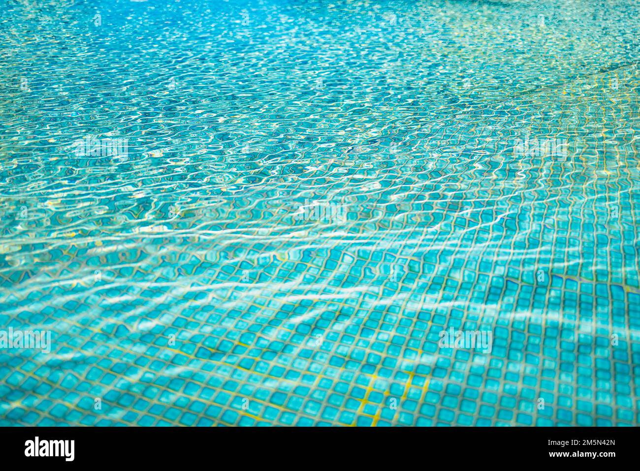 Beautiful relaxing swimming pool water sun reflection background. Ripple water texture background, natural sunlight. Abstract artistic water surface Stock Photo