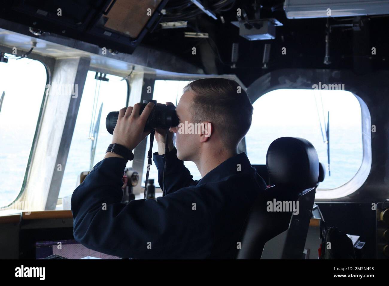 220328-O-NR876-007  PHILLIPPINE SEA (March 28, 2022) – Lt. j.g. Joshua Kraus, from Woodbridge, Virginia, stands watch as the Officer of the Deck aboard the Independence-variant littoral combat ship USS Charleston (LCS 18) during a division tactic (DIVTAC) exercise with the French Navy Floréal-class frigate FS Vendémiaire (F734). Charleston, part of Destroyer Squadron (DESRON) 7, is on a rotational deployment, operating in the U.S. 7th Fleet area of operations to enhance interoperability with partners and serve as a ready-response force in support of a free and open Indo-Pacific region. Stock Photo