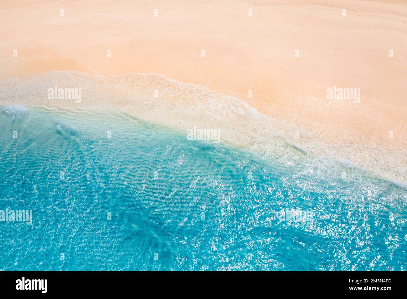 Summer seascape beautiful waves blue sea water in sunny day. Top view from drone. Sea aerial view, amazing tropical nature background. Beautiful coast Stock Photo