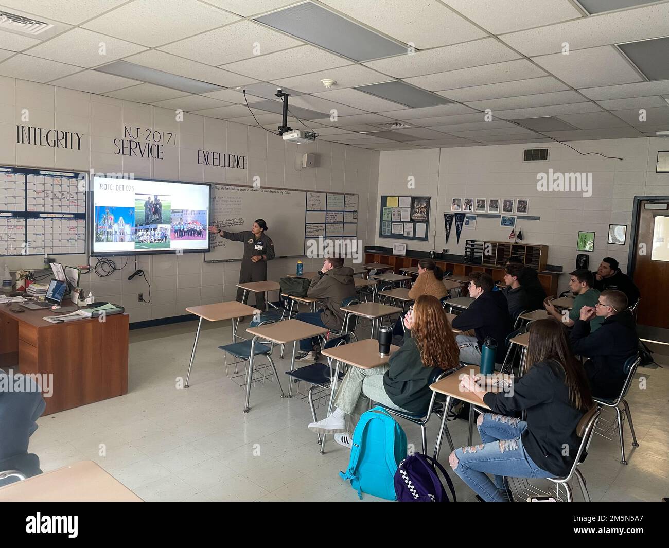 U.S. Air Force Capt. Irlanda Rodriguez from the 6th Airlift Squadron gives a presentation to level 300 and level 400 JROTC students on AIM High, North Burlington High school, New Jersey, Mar. 28, 2022. AIM Hight is an AFRS Detachment 1 mission geared towards informing, influencing, and inspiring tomorrow’s leaders through innovative outreach opportunities. Stock Photo