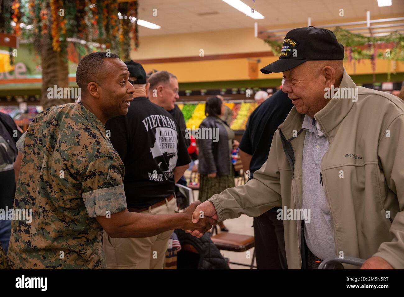 U.S. Marine Corps Col. Michael L. Brooks, base commander, Marine Corps Base Quantico, shakes hands with retired Gunnery Sgt. Clarence Cosby at the commissary on Marine Corps Base Quantico, Virginia, March 29, 2022. A ceremony was conducted to commemorate National Vietnam War Veterans Day. Stock Photo