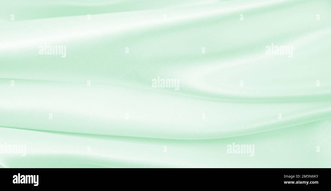 Smooth elegant green silk or satin luxury cloth texture can use as ...