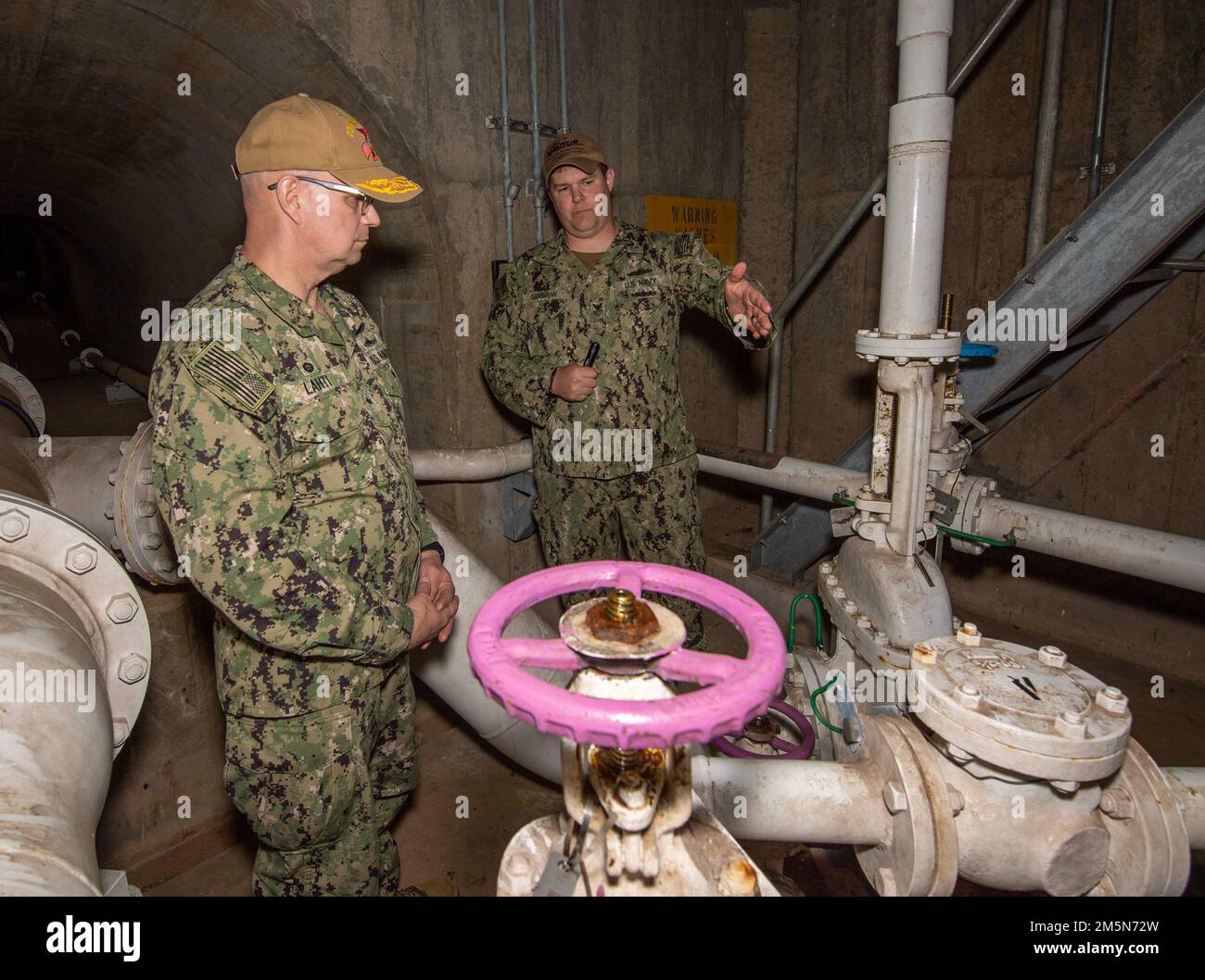 Boatswain’s Mate 1st Class Jeffrey Gansmann provides information about an underground fuel pipe