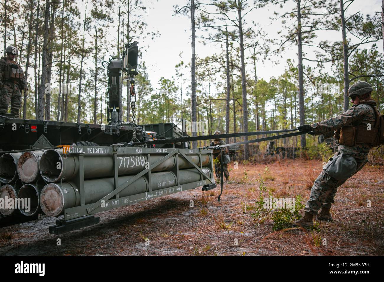 U.S. Marines with Sierra Battery, 2d Battalion, 10th Marine Regiment, load a reduced range practice rocket during Exercise Rolling Thunder 22-2 at Camp Lejeune, North Carolina, March 29, 2022. The Marines utilized the newly-fielded equipment gaining proficiency in constructing combat expedient roads and providing obstacle clearance for moving troops and logistics throughout a contested environment. Stock Photo