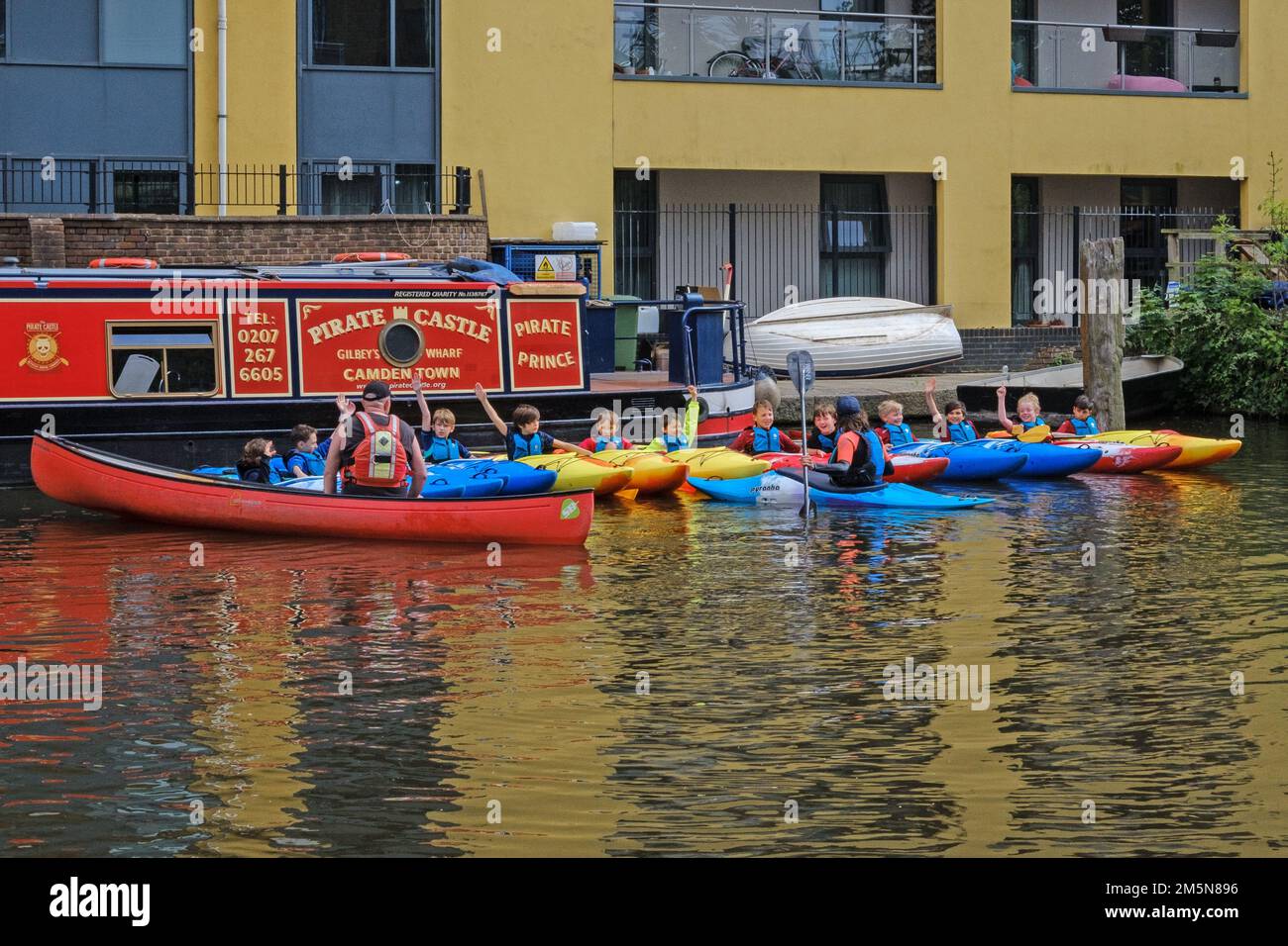 Children enjoying a Pirate Castle paddlesport session on kayaking. Regents Canal at Camden Town, London. Stock Photo