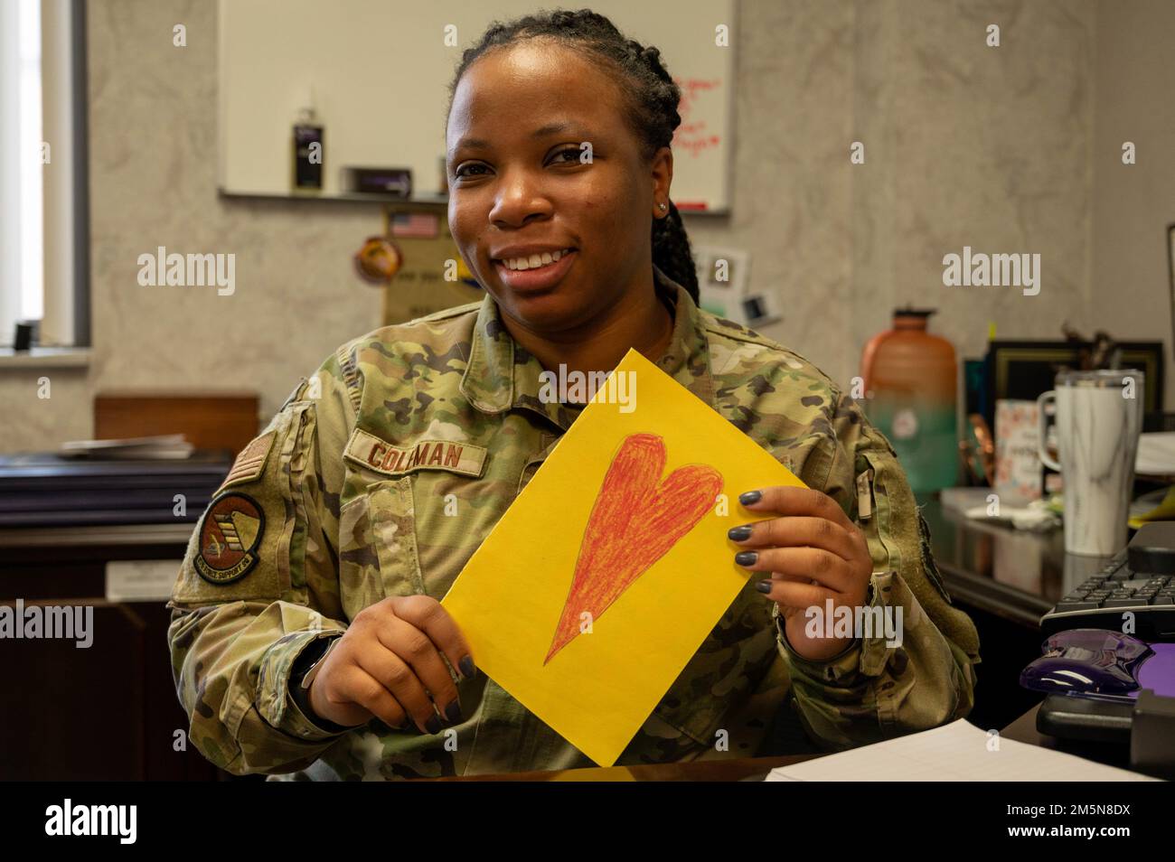 U.S. Air Force Airman 1st Class Amanda Coleman, 375th Force Support Squadron commander support staff specialist, holds up a letter written for Women’s History Month on Scott Air Force Base, Illinois, March 29, 2022. Students at Scott Elementary School wrote letters to women of Team Scott, recognizing them for their service to their country. Stock Photo