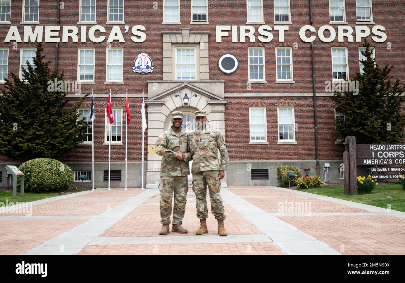 Lt. Gen. Xavier Brunson, left, Commanding General of America's First Corps, and Lt. Gen. Gary Brito, right, deputy chief of staff G-1 Personnel of The United States Army, shake hands in front of America’s First Corps headquarters at Joint Base Lewis-McChord, Wash. March 29, 2022. Lt. Gen. Brito’s visit included attending an app demo for Personnel Accountability and discussing “Navigating Family Readiness” with a focus group of Soldiers from various units throughout JBLM. Stock Photo