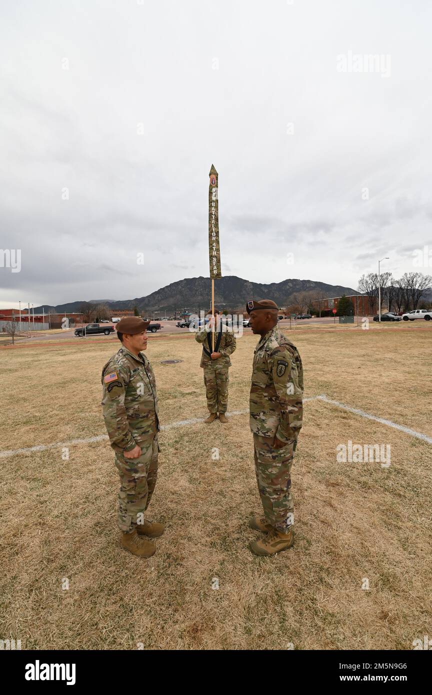 Lt. Col. Sean Shields, commander, 5th Bn., 4th Security Force Assistance Brigade (SFAB) and Command Sgt. Maj. Dunte Bennett, command sergeant major, 5th Bn., 4th SFAB furl the unit colors during a casing ceremony at Pershing Field, Ft. Carson, Colorado, on March 29, 2022. Stock Photo