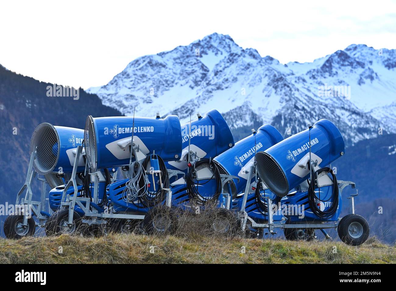 Oberstdorf, Deutschland. 28th Dec, 2022. Snow cannons from the manufacturer Demaclenko stand on a meadow on a mild winter day.The warm weather does not allow snow production. ? Credit: dpa/Alamy Live News Stock Photo