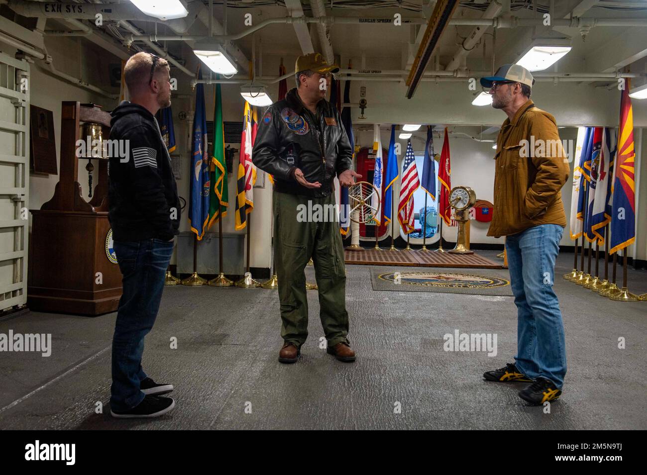 220329-N-OL632-1016 NAVAL STATION NORFOLK (March 29, 2022) Capt. Robert Aguilar, commanding officer of USS George H.W. Bush (CVN 77), talks with NASCAR Hall of Famer Dale Earnhardt Jr. and NASCAR Xfinity Series driver Justin Allgaier during a visit to the ship, March 29, 2022. George H.W. Bush provides the national command authority flexible, tailorable war fighting capability as the flagship of the carrier strike group which maintains maritime stability and security in order to ensure access, deter aggression and defend U.S., allied and partner interests. Stock Photo