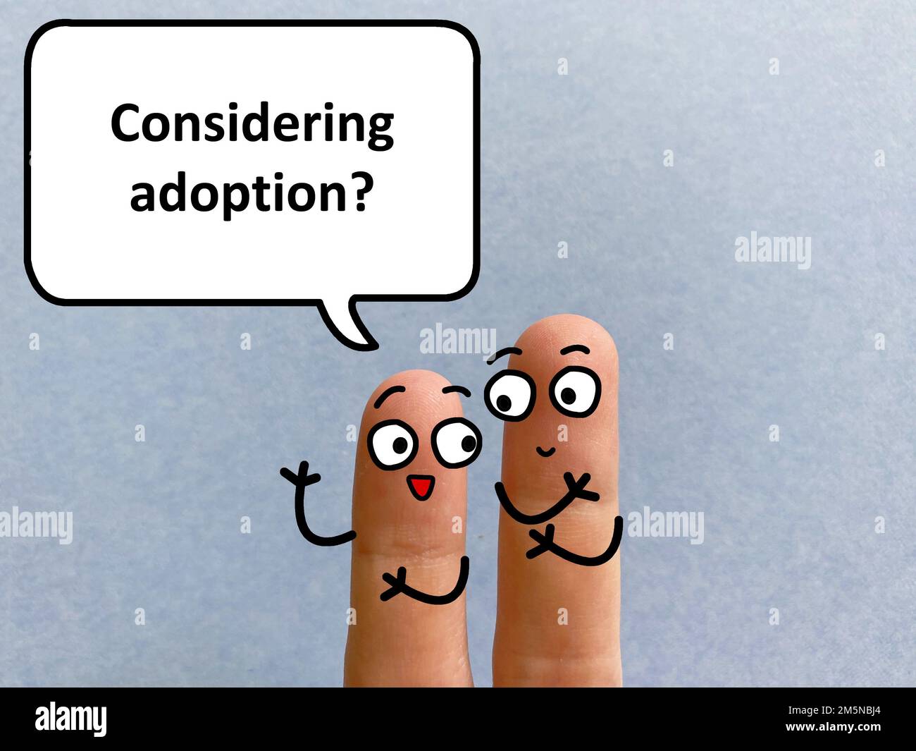 Two fingers are decorated as two person. One of them is asking another if he is considering adoption. Stock Photo