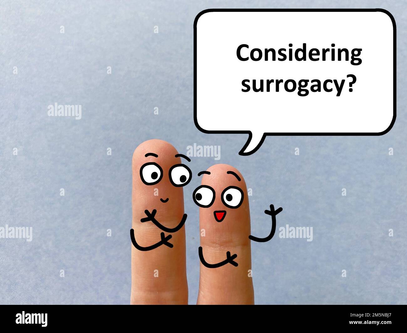 Two fingers are decorated as two person. One of them is asking another if he is considering surrogacy. Stock Photo