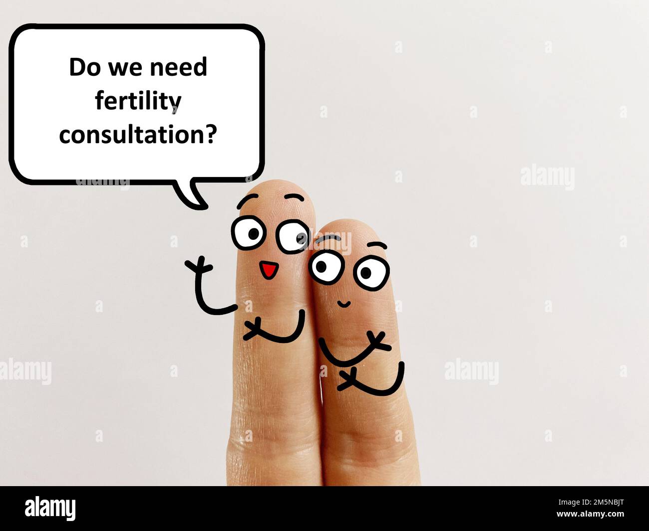 Two fingers are decorated as two person. One of them is asking another if they need fertility consultation. Stock Photo