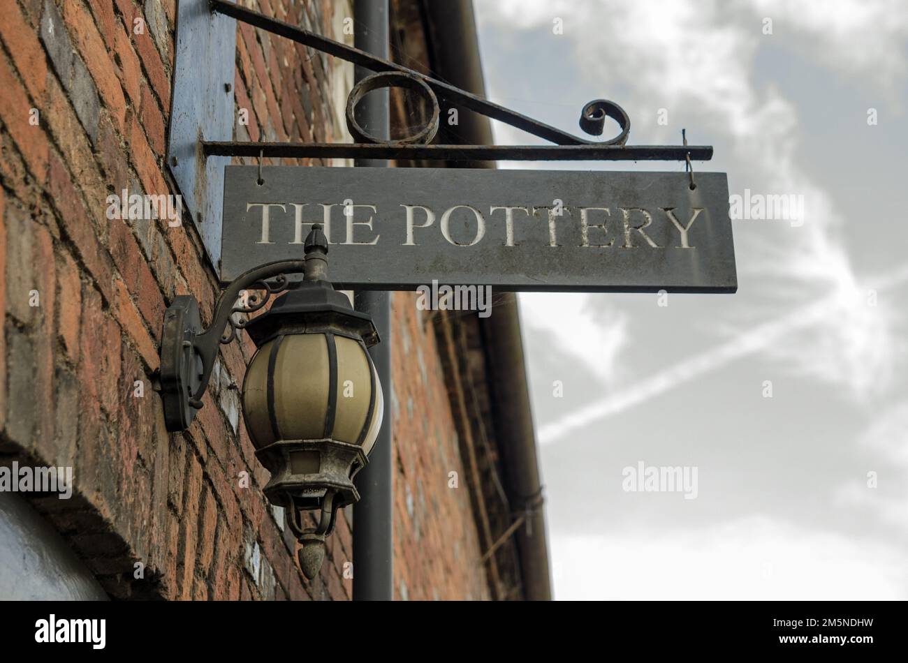 Aldermaston, UK - October 27, 2021:  Historic sign for the pottery in Aldermaston village, Berkshire.  The art pottery created renowned works in the m Stock Photo