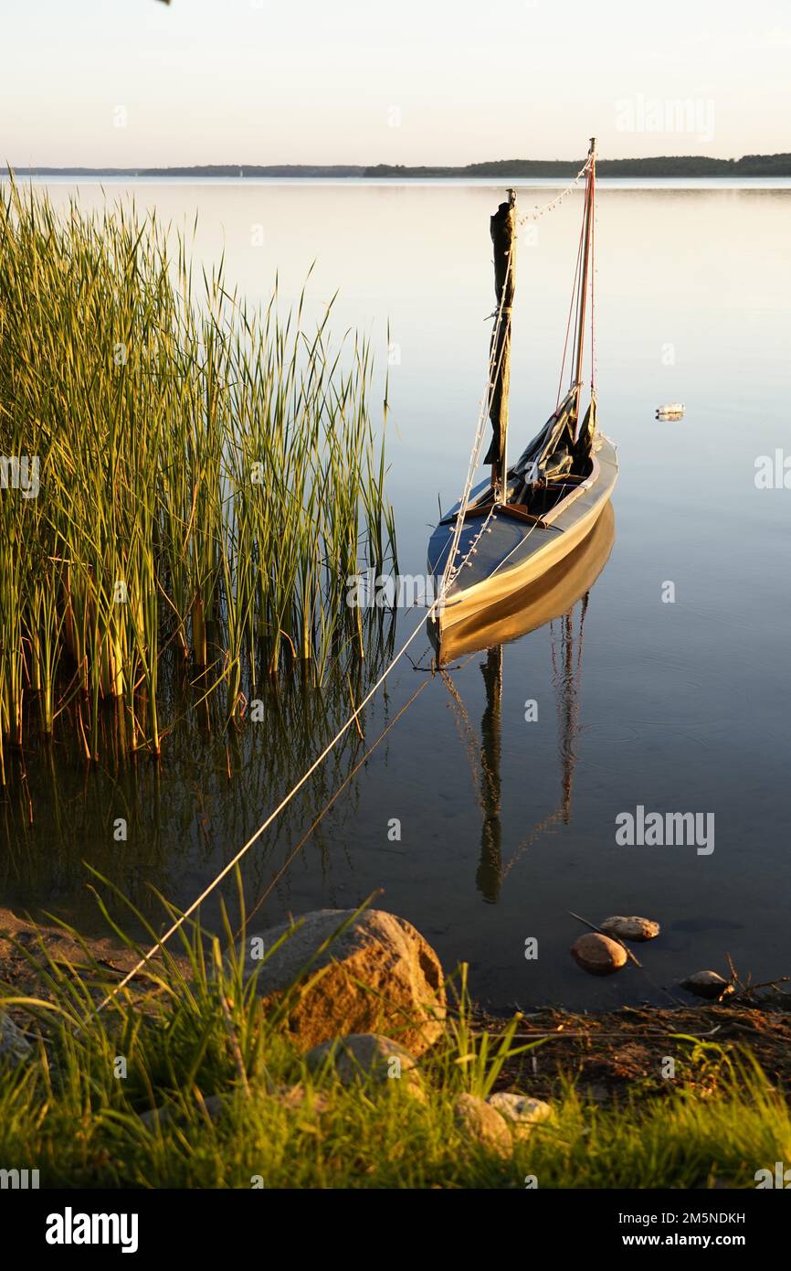Folding boat with sail, evening mood, Lake Plauer See, Plau am See, Mecklenburg-Western Pomerania, Germany Stock Photo