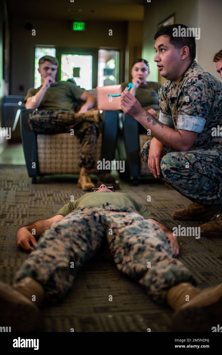 U.S. Navy Hospital Corpsman 3rd Class Daniel Laneygarcia with the 15th Marine Expeditionary Unit demonstrates how to use a nasopharyngeal airway on a simulated casualty during a Combat Lifesaver (CLS) Course at Marine Corps Base Camp Pendleton, California, March 29, 2022. CLS is a three-day course that teaches Marines lifesaving medical techniques to eliminate preventable loss of life on the battlefield. Stock Photo