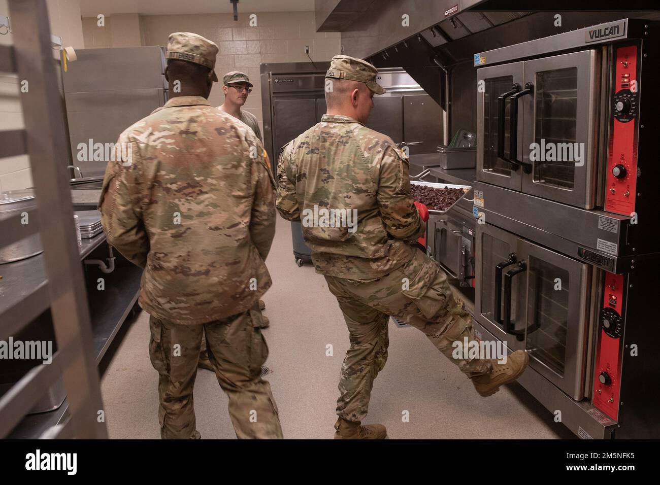 Idaho Army National Guard  Pfc. Ethan Mitchell (right) and Spc. Jonah Dittenber preparing the evening meals.    Napoleon Bonaparte is attributed as saying - “An army marches on it’s stomach.” The saying conveys the importance that soldiers in the field cannot be effective unless they are well fed.    The Idaho Army National Guard's 2-116th Combined Arms Battalion was in the field on the Orchard Combat Training Center in the final days of March, in preparation for an upcoming deployment in support of Operation Spartan Shield.    The training was rigorous and diverse. While each company complete Stock Photo