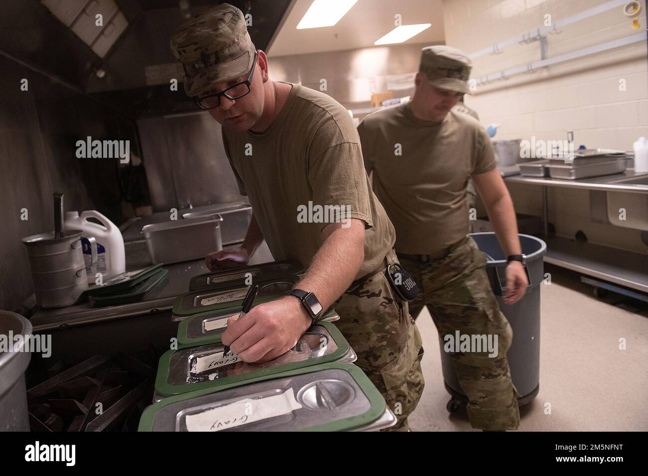 Idaho Army National Guard Sgt. Curtis Bishop writes meal destination on top of containers.    Napoleon Bonaparte is attributed as saying - “An army marches on it’s stomach.” The saying conveys the importance that soldiers in the field cannot be effective unless they are well fed.    The Idaho Army National Guard's 2-116th Combined Arms Battalion was in the field on the Orchard Combat Training Center in the final days of March, in preparation for an upcoming deployment in support of Operation Spartan Shield.    The training was rigorous and diverse. While each company completed their individual Stock Photo