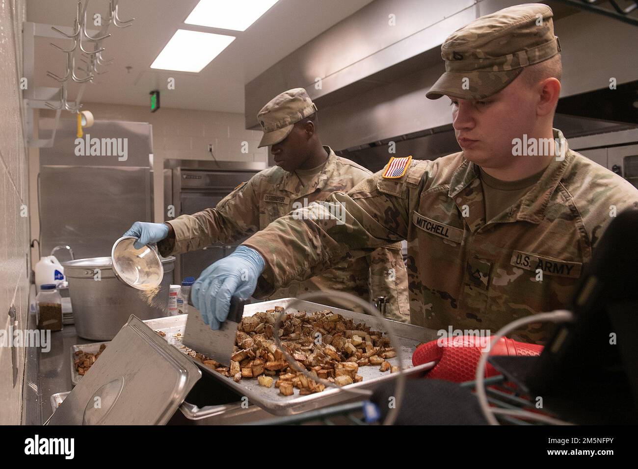 Idaho Army National Guard Spc. Jonah Dittenber (left) and Pfc. Ethan Mitchell cooking in the kitchen.    Napoleon Bonaparte is attributed as saying - “An army marches on it’s stomach.” The saying conveys the importance that soldiers in the field cannot be effective unless they are well fed.    The Idaho Army National Guard's 2-116th Combined Arms Battalion was in the field on the Orchard Combat Training Center in the final days of March, in preparation for an upcoming deployment in support of Operation Spartan Shield.    The training was rigorous and diverse. While each company completed their Stock Photo