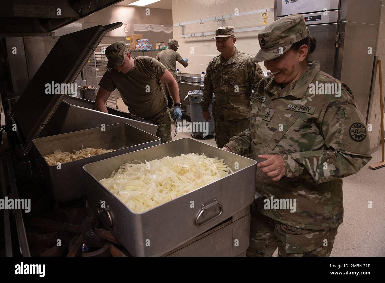 Idaho Army National Guard Sgt. 1st. Class Gladys Montelongo checks the progress of food preparation.    Napoleon Bonaparte is attributed as saying - “An army marches on it’s stomach.” The saying conveys the importance that soldiers in the field cannot be effective unless they are well fed.    The Idaho Army National Guard's 2-116th Combined Arms Battalion was in the field on the Orchard Combat Training Center in the final days of March, in preparation for an upcoming deployment in support of Operation Spartan Shield.    The training was rigorous and diverse. While each company completed their Stock Photo