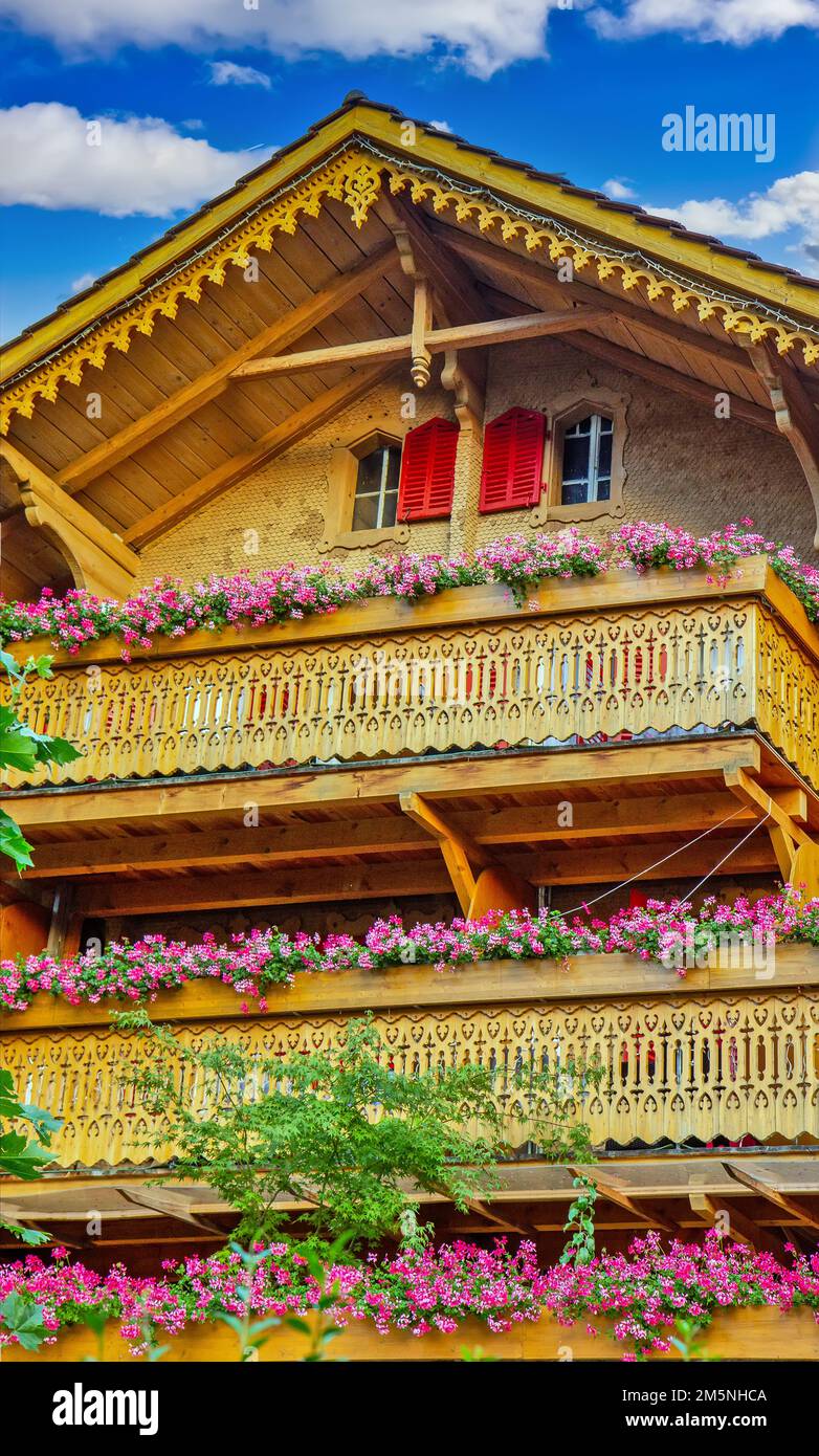 Old wooden house with flowers on the balcony in Switzerland Alps Stock