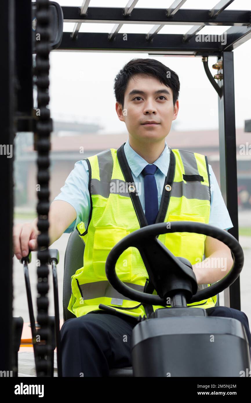 Logistics warehouse workers forklift driving Stock Photo Alamy