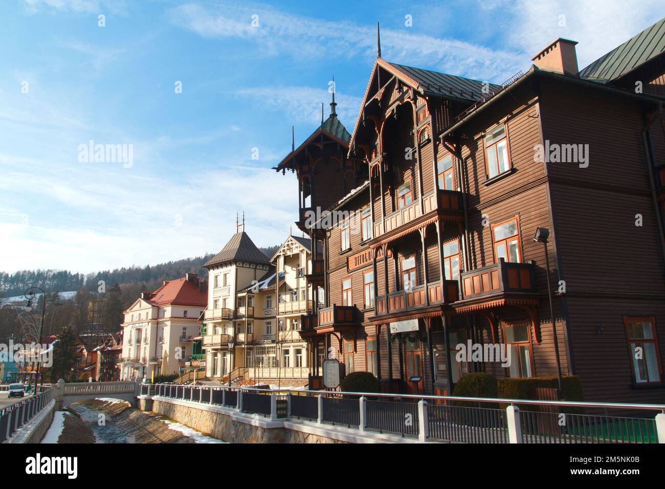 old wooden buildings in Krynica Zdroj Poland with local stream Stock Photo
