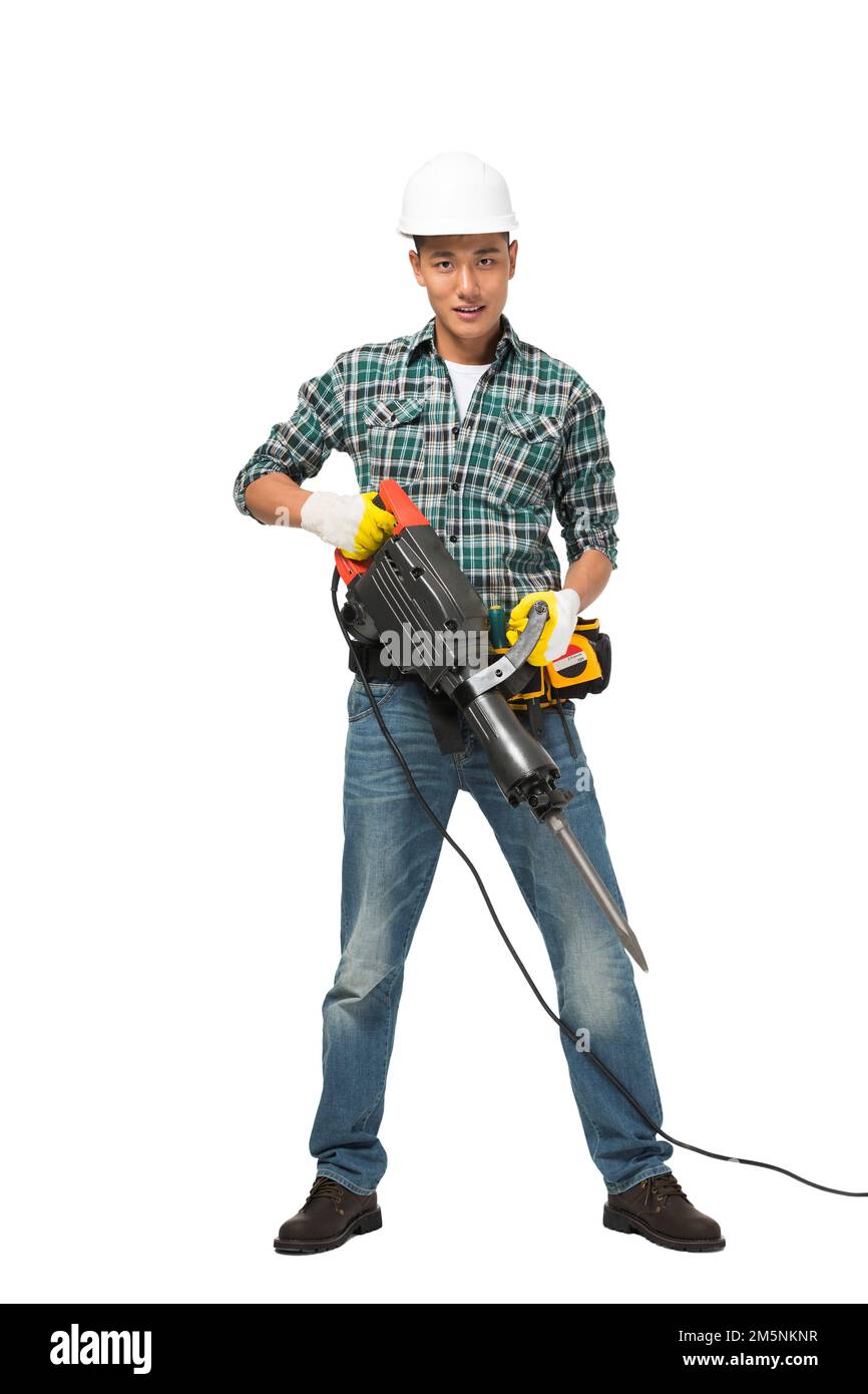 Young construction workers take percussion drill Stock Photo - Alamy