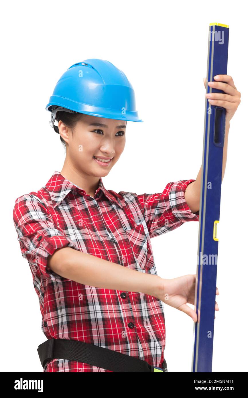 Young female construction workers with a level Stock Photo Alamy