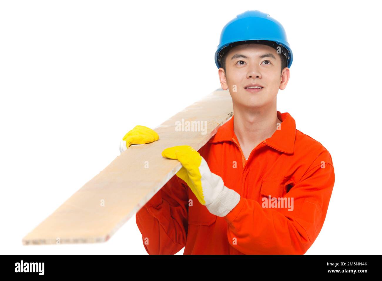 Young construction workers carry building materials Stock Photo Alamy