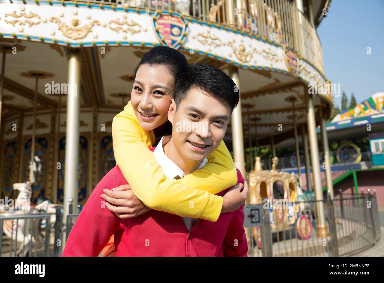 Young couples to play in the amusement park Stock Photo - Alamy