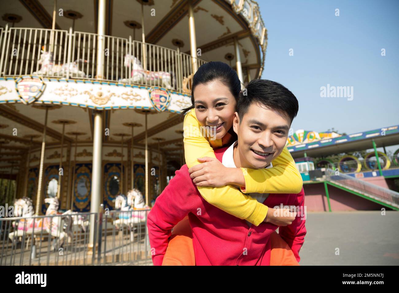 Young couples to play in the amusement park Stock Photo - Alamy