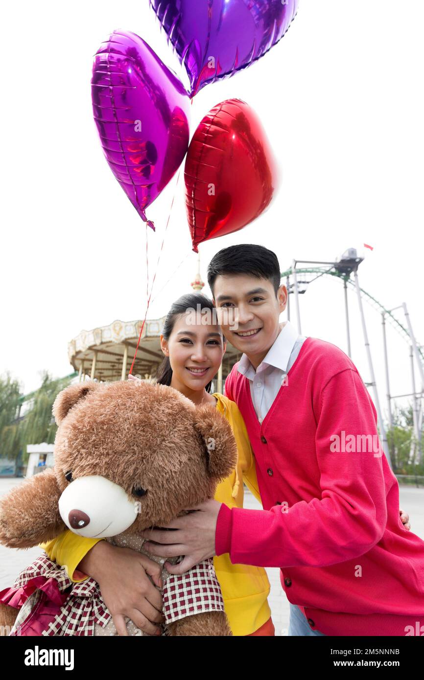 Young couples to play in the amusement park Stock Photo - Alamy
