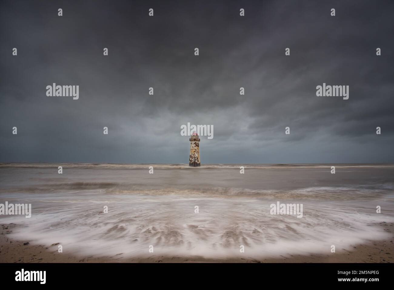 weather battered Lighthouse in a landscape photograph surrounded by sea ...