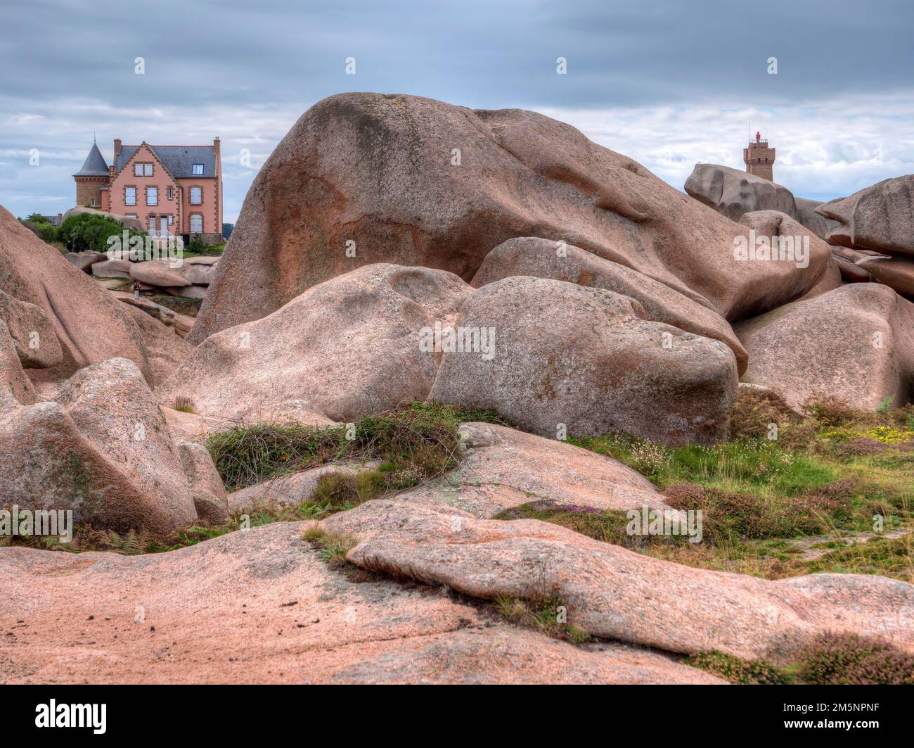 The granite rocks of the Cote Granit Rose and in the background the ...