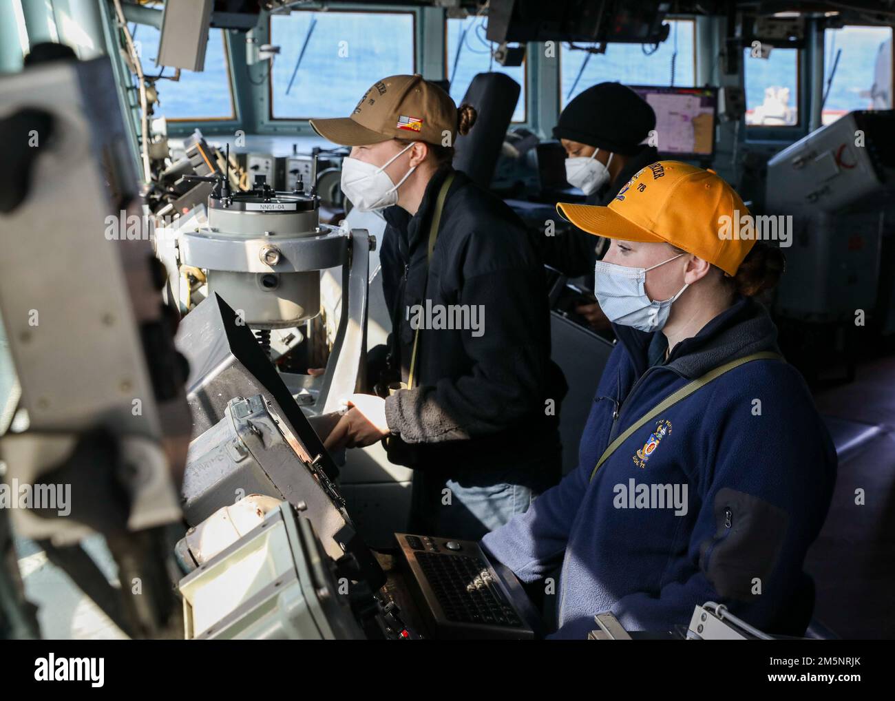 ATLANTIC OCEAN (Feb. 26, 2022) – Lt. j.g. Rebecca Ouellette, left, Ensign Cayla Hannibal, center, and Lt. j.g. Brinn Hefron man the bridge while underway aboard the Arleigh Burke-class guided-missile destroyer USS Porter (DDG 78), Feb. 26, 2022. Porter, forward-deployed to Rota, Spain, is currently underway in the U.S. Sixth Fleet area of operations in support of regional allies and partners and U.S. national security interests in Europe and Africa. Stock Photo