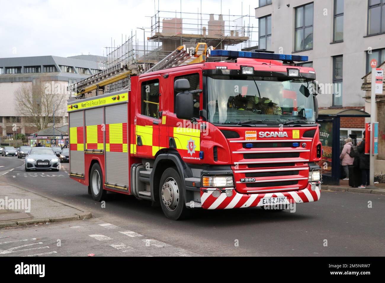 KENT FIRE AND RESCUE SERVICE FIRE ENGINE TRUCK TRAVELLING ALONG A ROAD