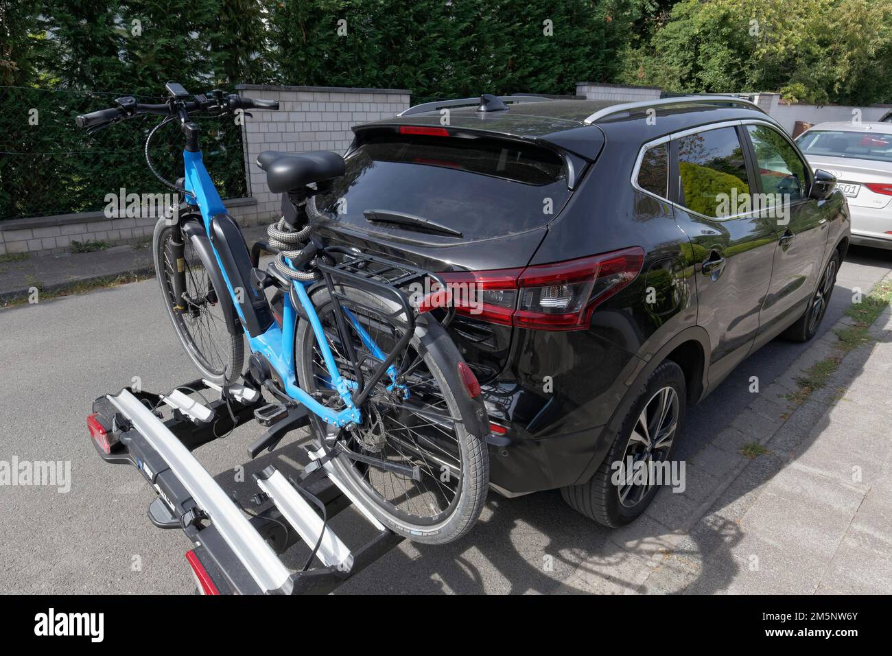 Car with e-bike on rear bike rack, parked on the road, Duesseldorf, North Rhine-Westphalia, Germany Stock Photo