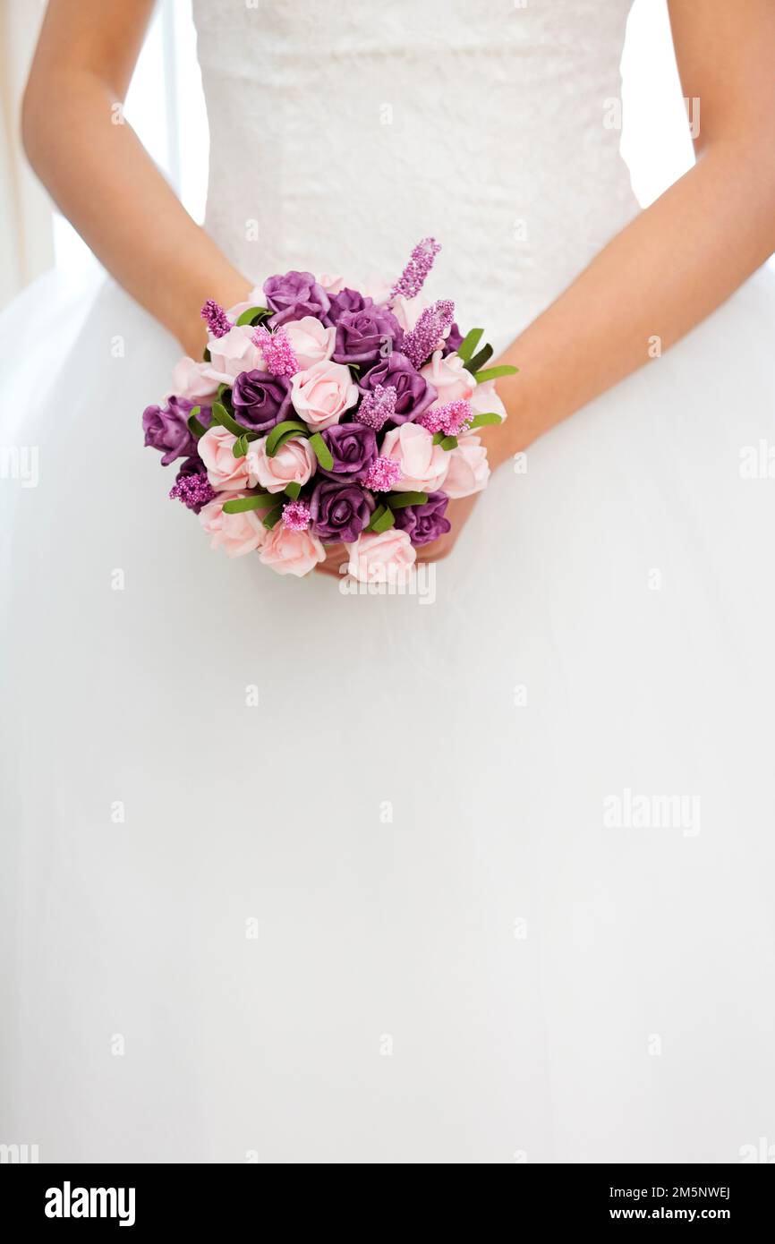 The beautiful bride holding flowers Stock Photo